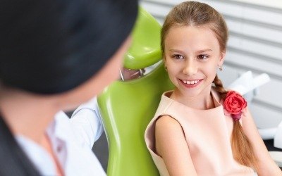 Child smiling at children's dentist