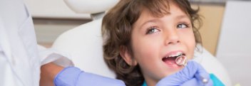 Child smiling during visit to children's dentist