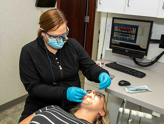 Dental team member providing a teeth cleaning