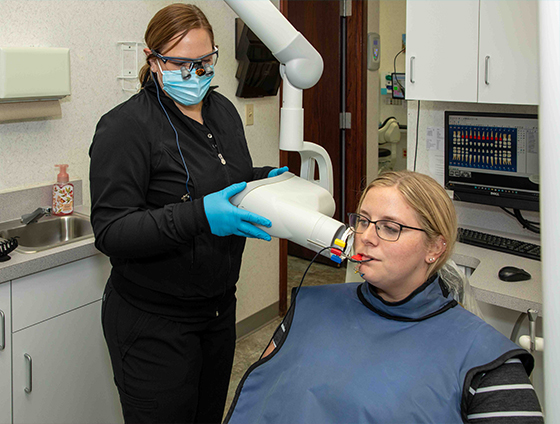 Dental patient receiving x rays during dental bridge treatment planning visit