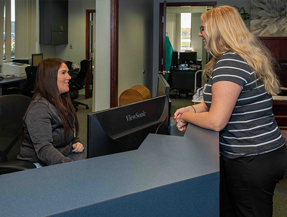 Dentistry team member talking to new dental patient