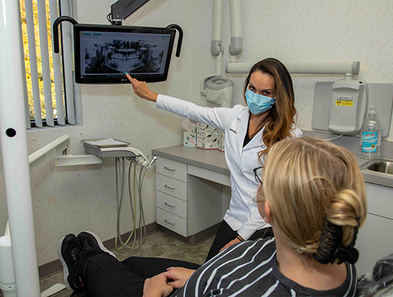 Dentist discussing lip fillers with dental patient