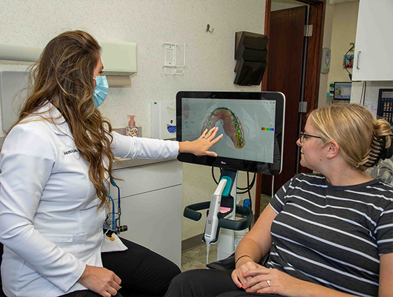 Dentist discussing restorative dentistry with dental patient