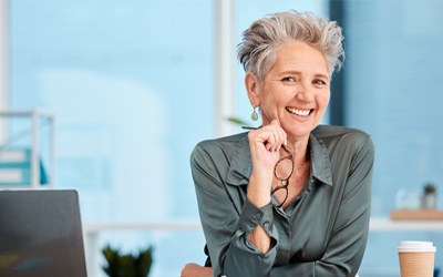 Woman smiling at a desk