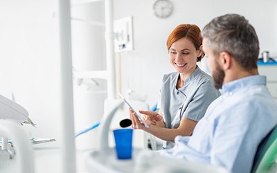 a dentist explaining the cost of dental implants in Cincinnati