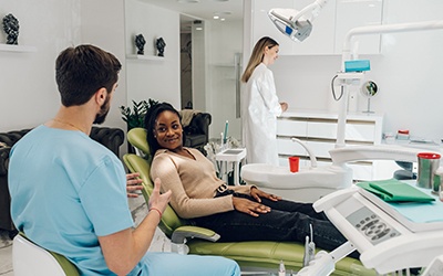 a dental assistant speaking with a patient
