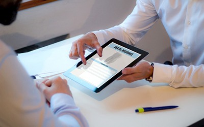 Office manager reviewing dental insurance information with patient