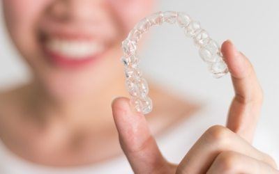 Hand holding an Invisalign tray