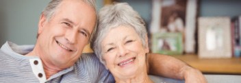 Man and woman smiling after restorative dentistry