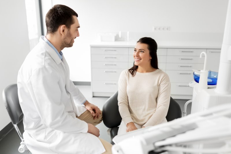 dentist talking to patient about dental implants