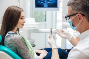 Woman at her dental implant consultation ready to ask questions