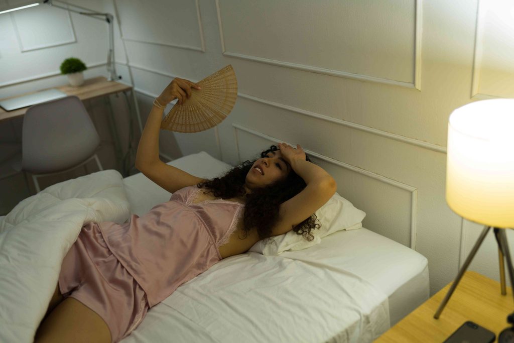 Woman trying to sleep in a hot room