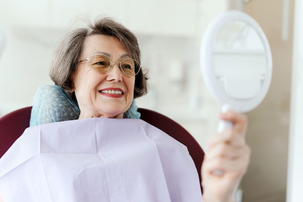 A woman looking at her newly restored smile